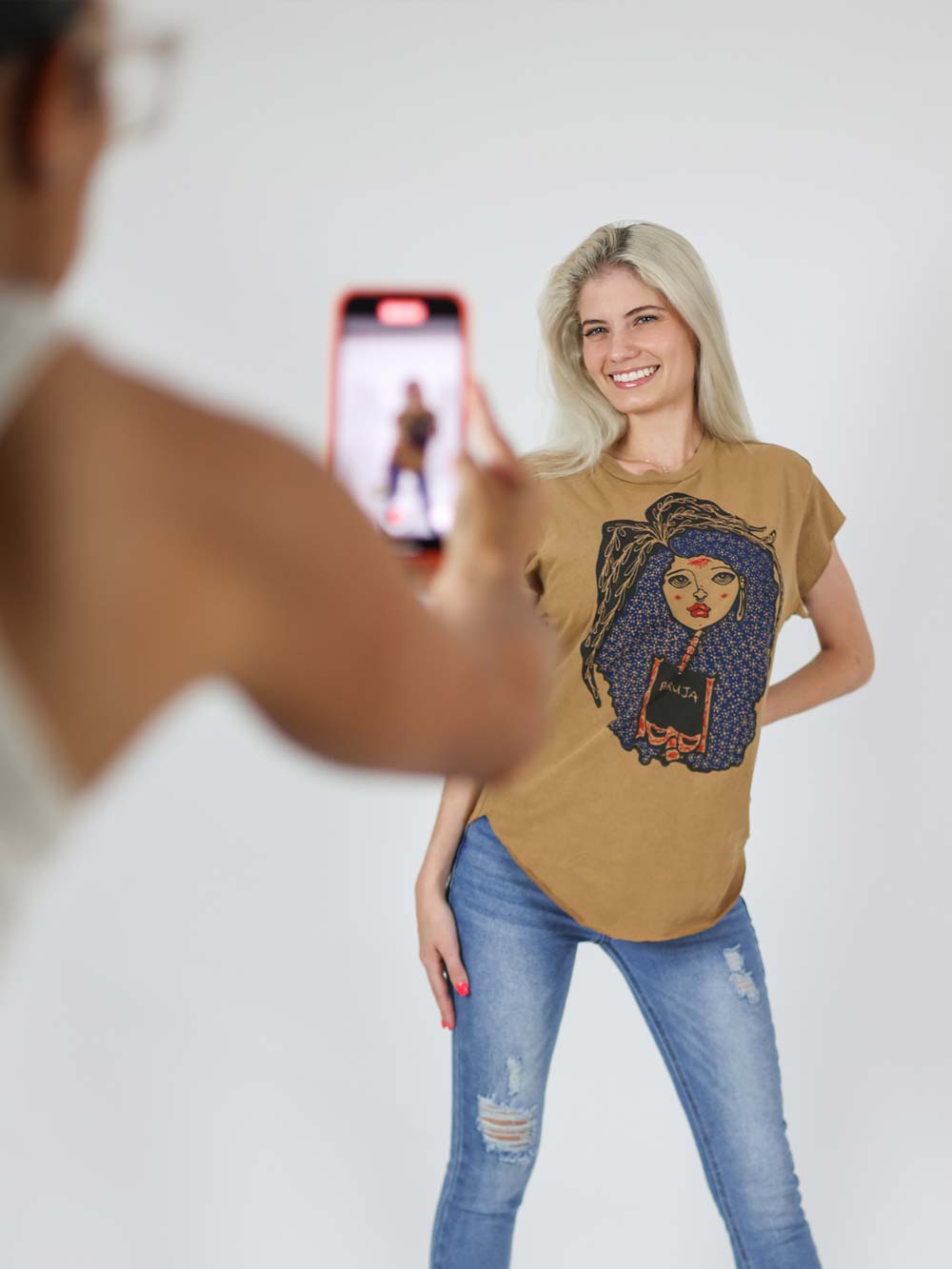 Taking picture of model wearing bruja Shirt