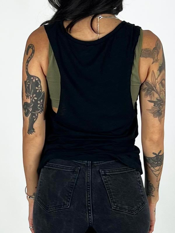 back of model in black tank top