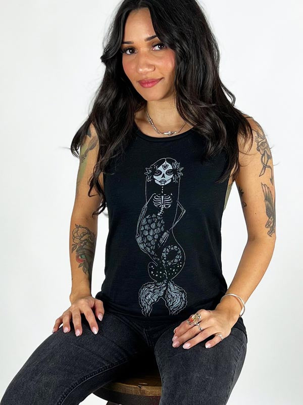 Model wearing black tank top with mermaid design