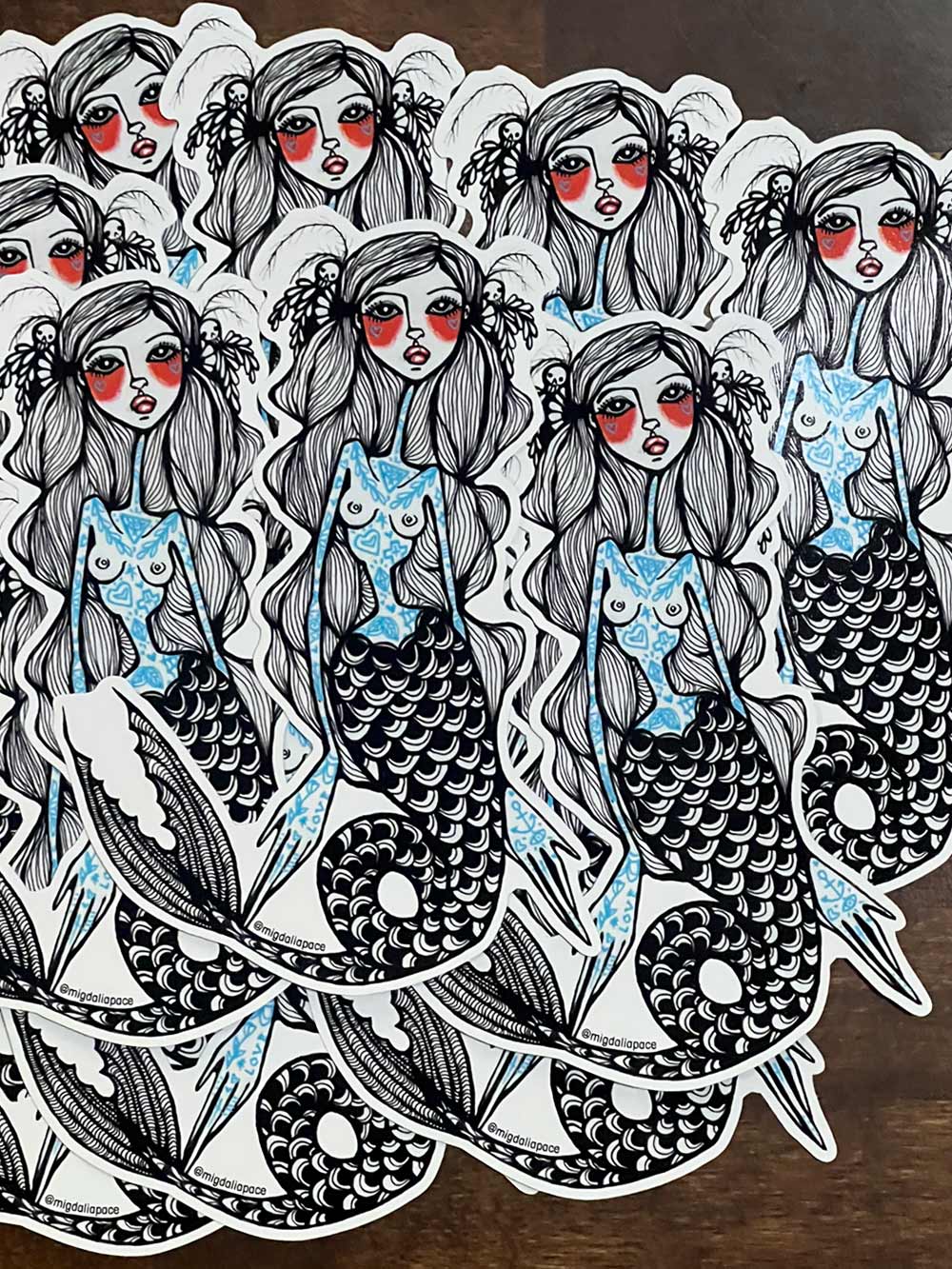 Sticker design of a mermaid with blue scales on a white background