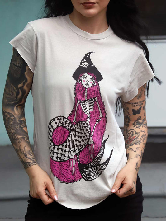 Person wearing a white t-shirt with a colorful mermaid design.