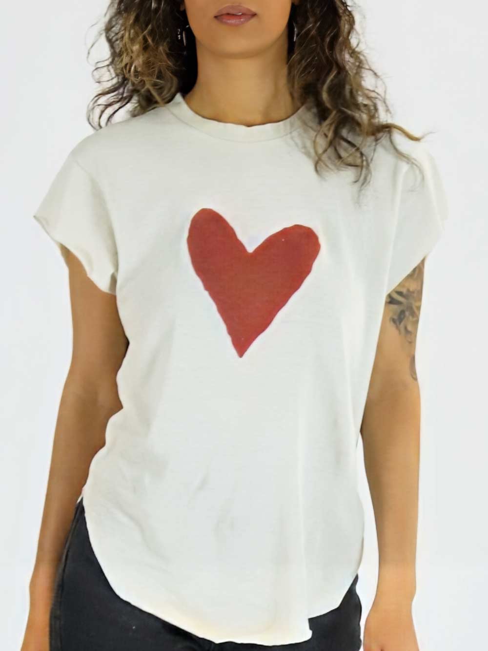 Model wearing a white t-shirt with a red heart design on a plain background