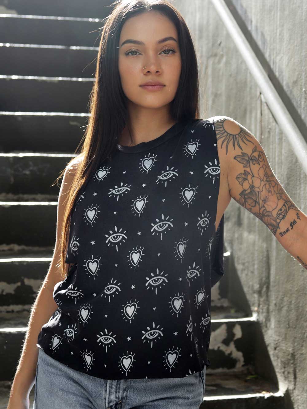 Model wearing a vintage black crop top with heart and third eye patterns. 