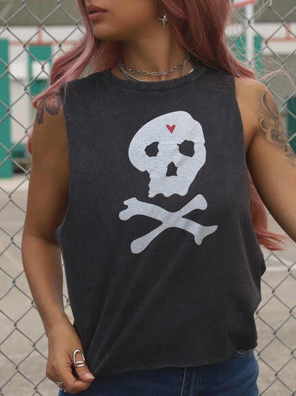 Female wearing a black crop top with a skull and crossbones design.