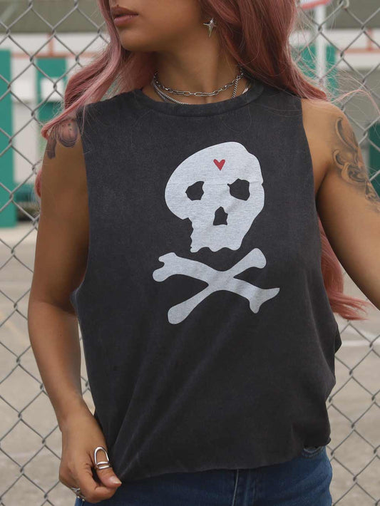 Female wearing a black crop top with a skull and crossbones design.