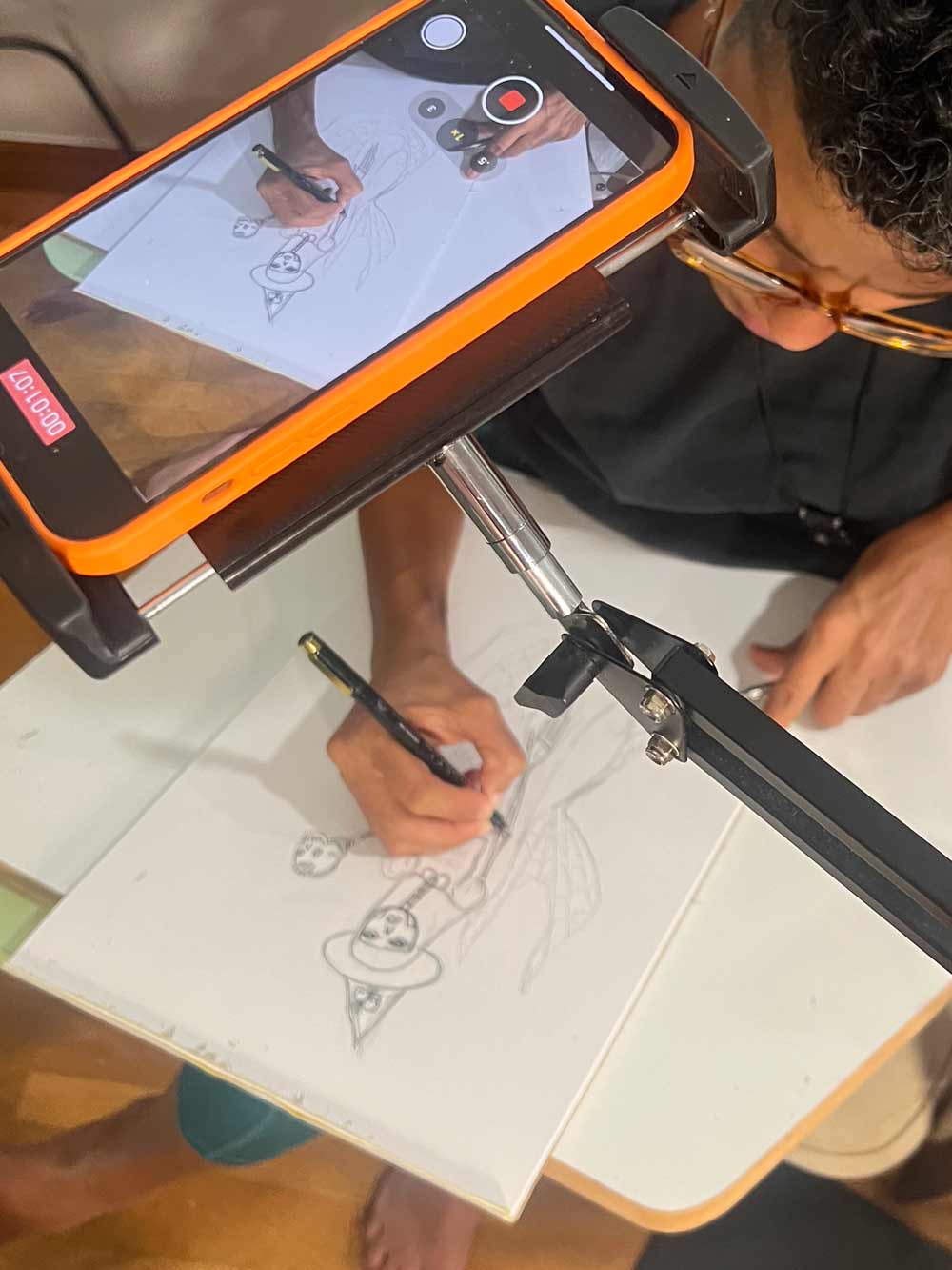 Migdalia recording her drawing a mermaid witch.
