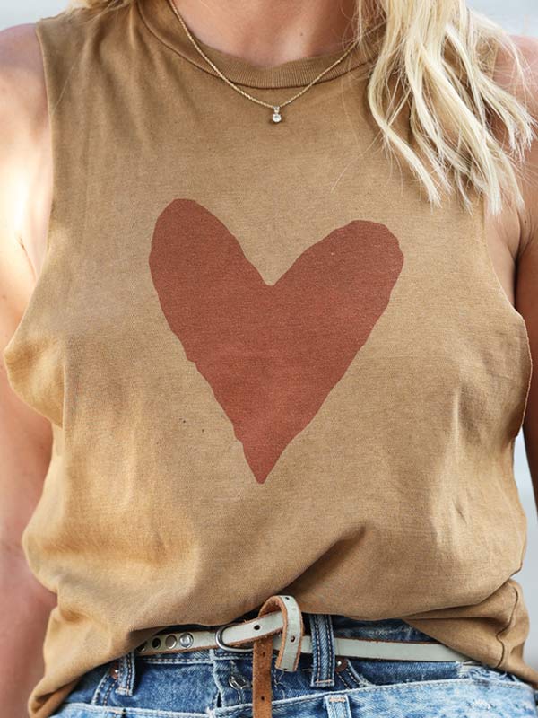 Close up of a red heart print on camel color crop top