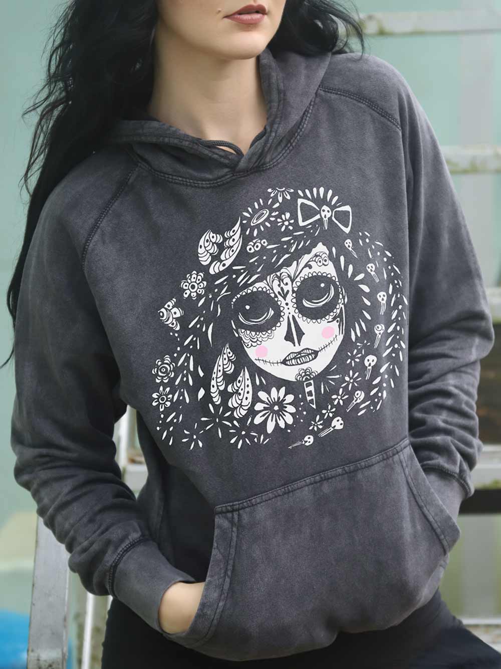 Woman wearing a vintage black hoodie with a sugar skull design.