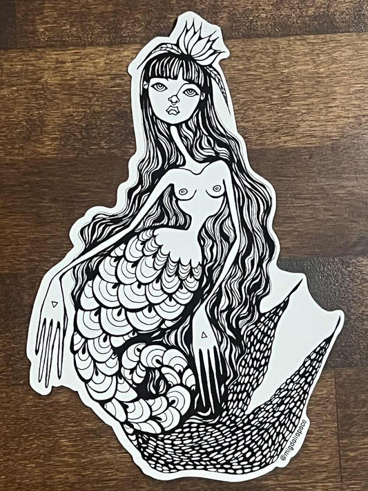 Black and white mermaid sticker on a wooden surface