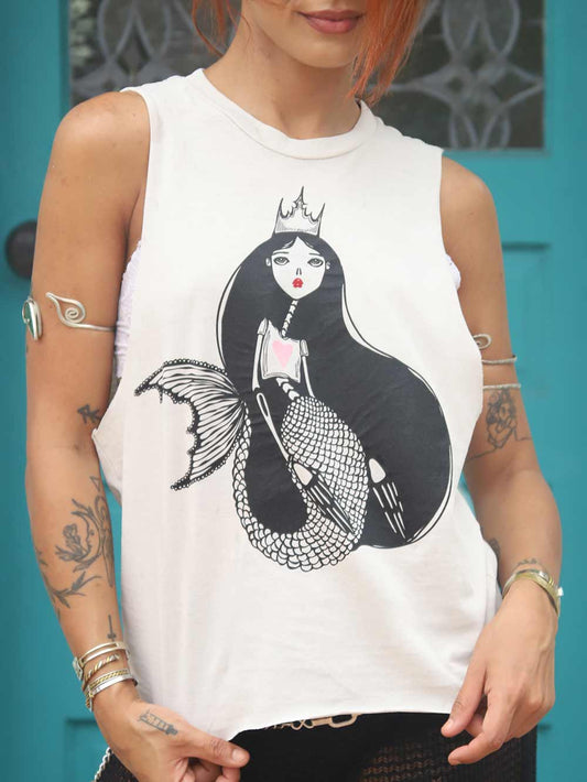 Woman wearing a white crop top with a cute mermaid graphic design.