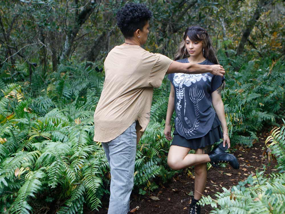 Designer helping model with skeleton mermaid shirt