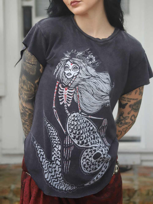 Model wearing a black t-shirt with a skeleton mermaid design.