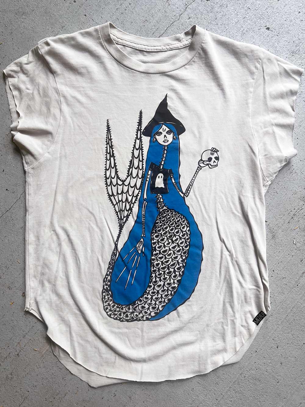 White t-shirt with a graphic design of a witch mermaid.  