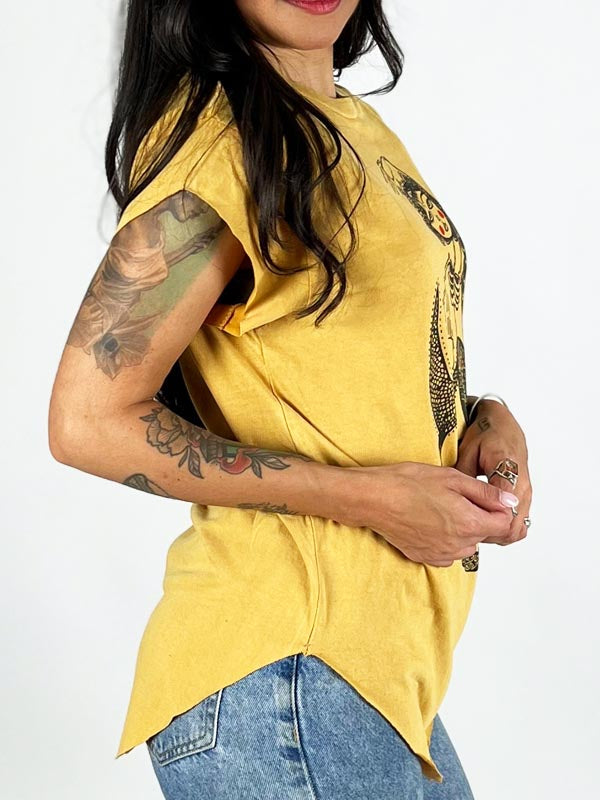 modeling with tattoos wearing a yellow boyfriend graphic tee