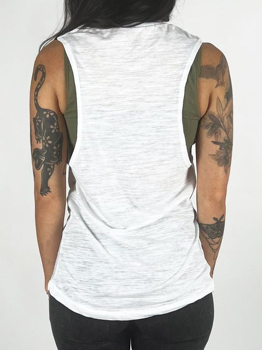 back of model w/ tattoos in white tank top